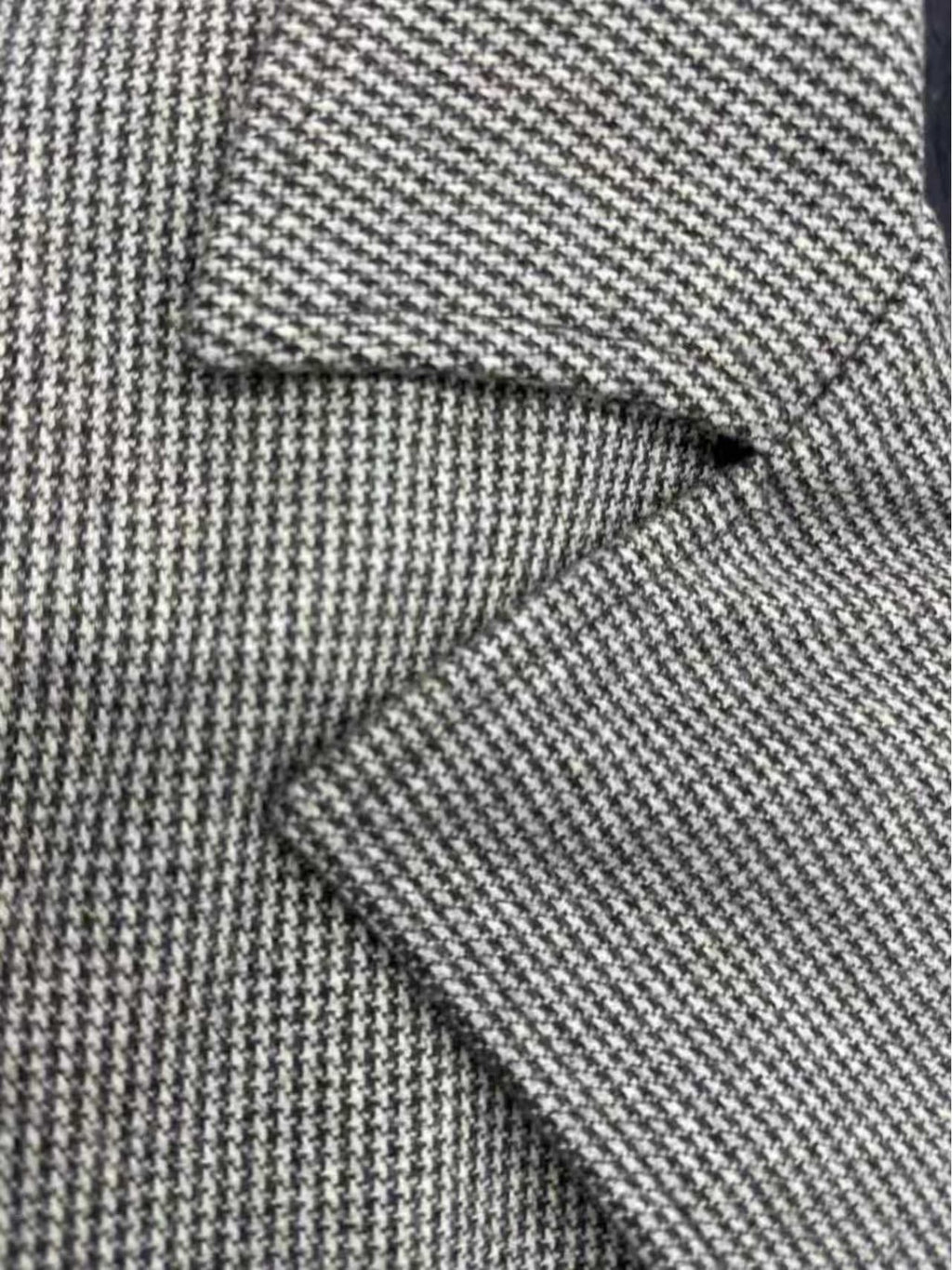 Close-up of the men's houndstooth overcoat fabric and stitching