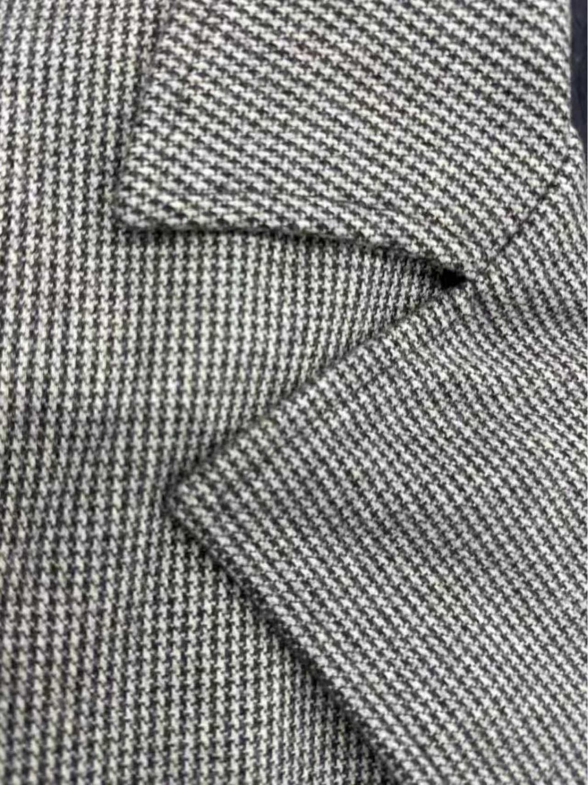 Close-up of the men's houndstooth overcoat fabric and stitching