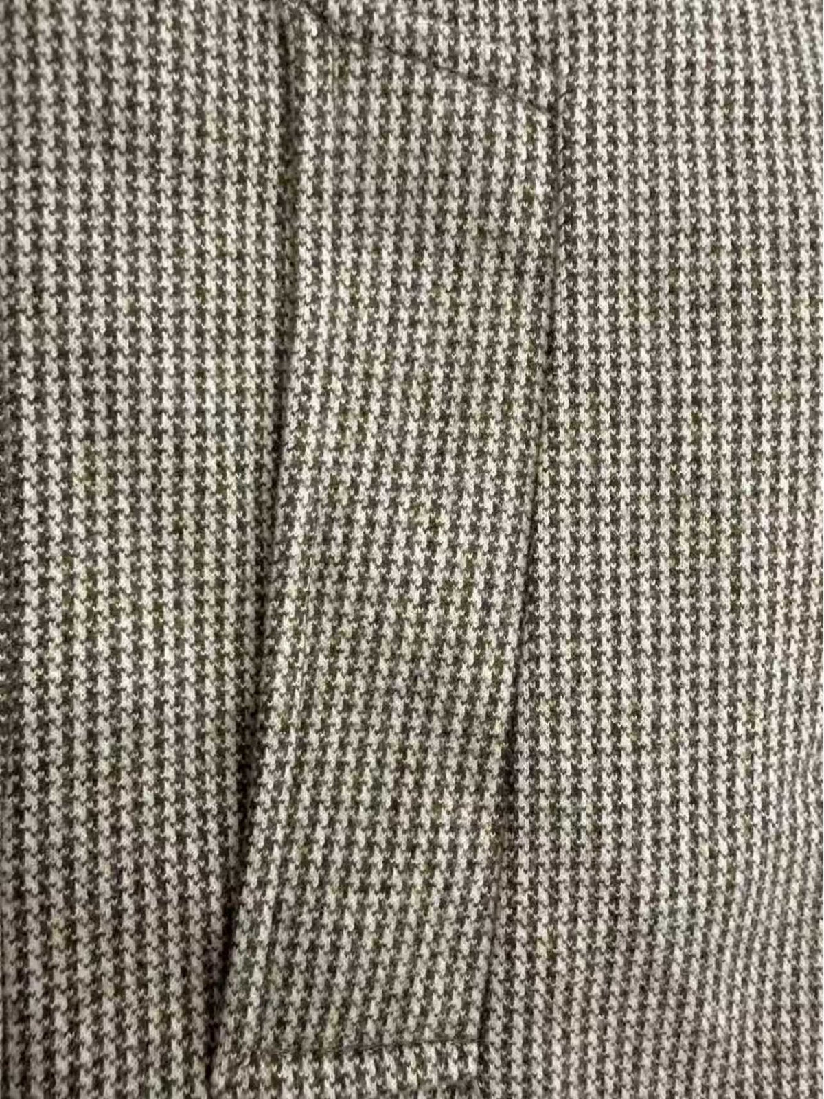 Collar and fastening detail of the men's houndstooth overcoat