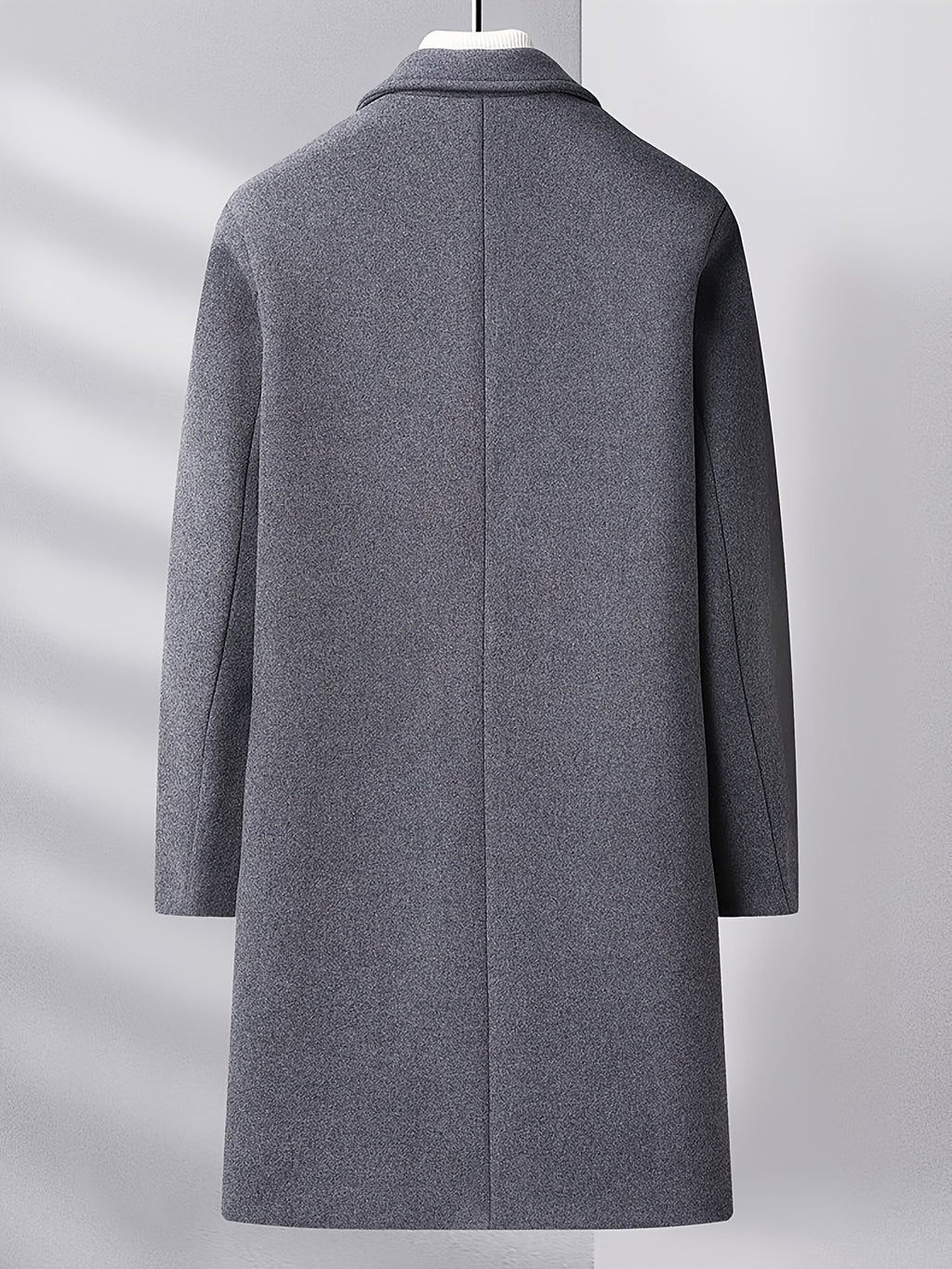 Close-up of the men's knee-length wool overcoat fabric and stitching