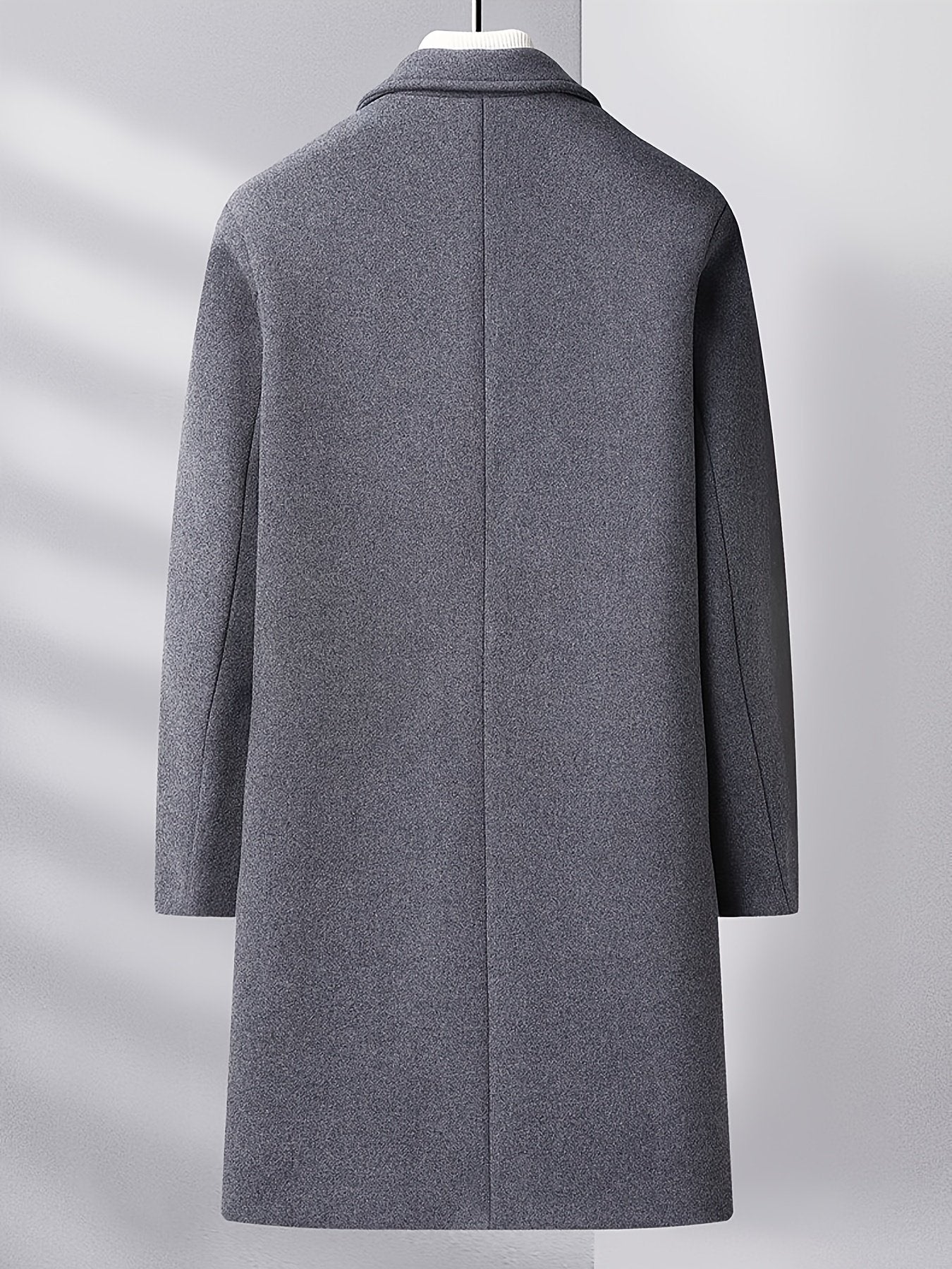 Close-up of the men's knee-length wool overcoat fabric and stitching