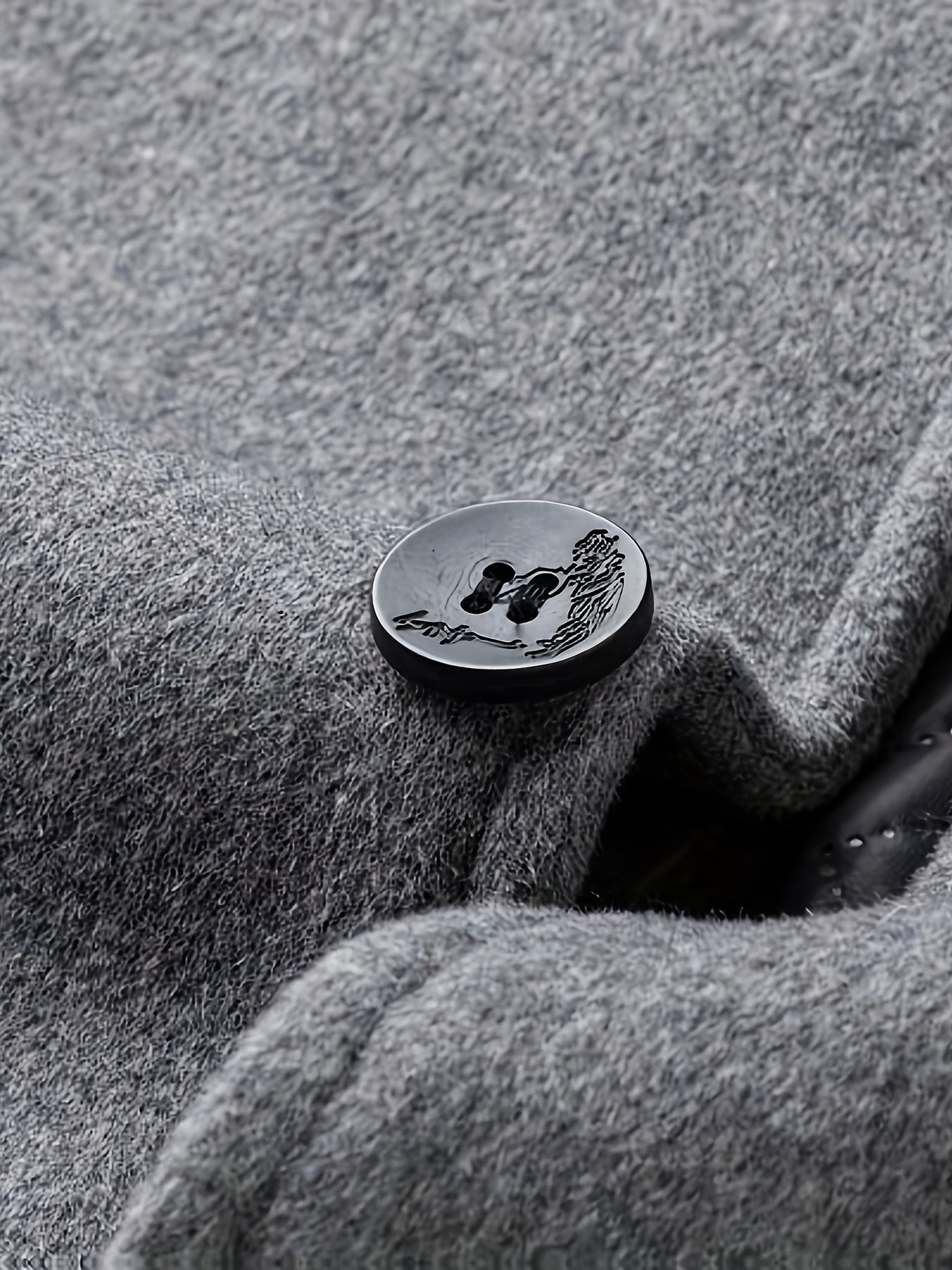 Collar and fastening detail of the men's knee-length wool overcoat