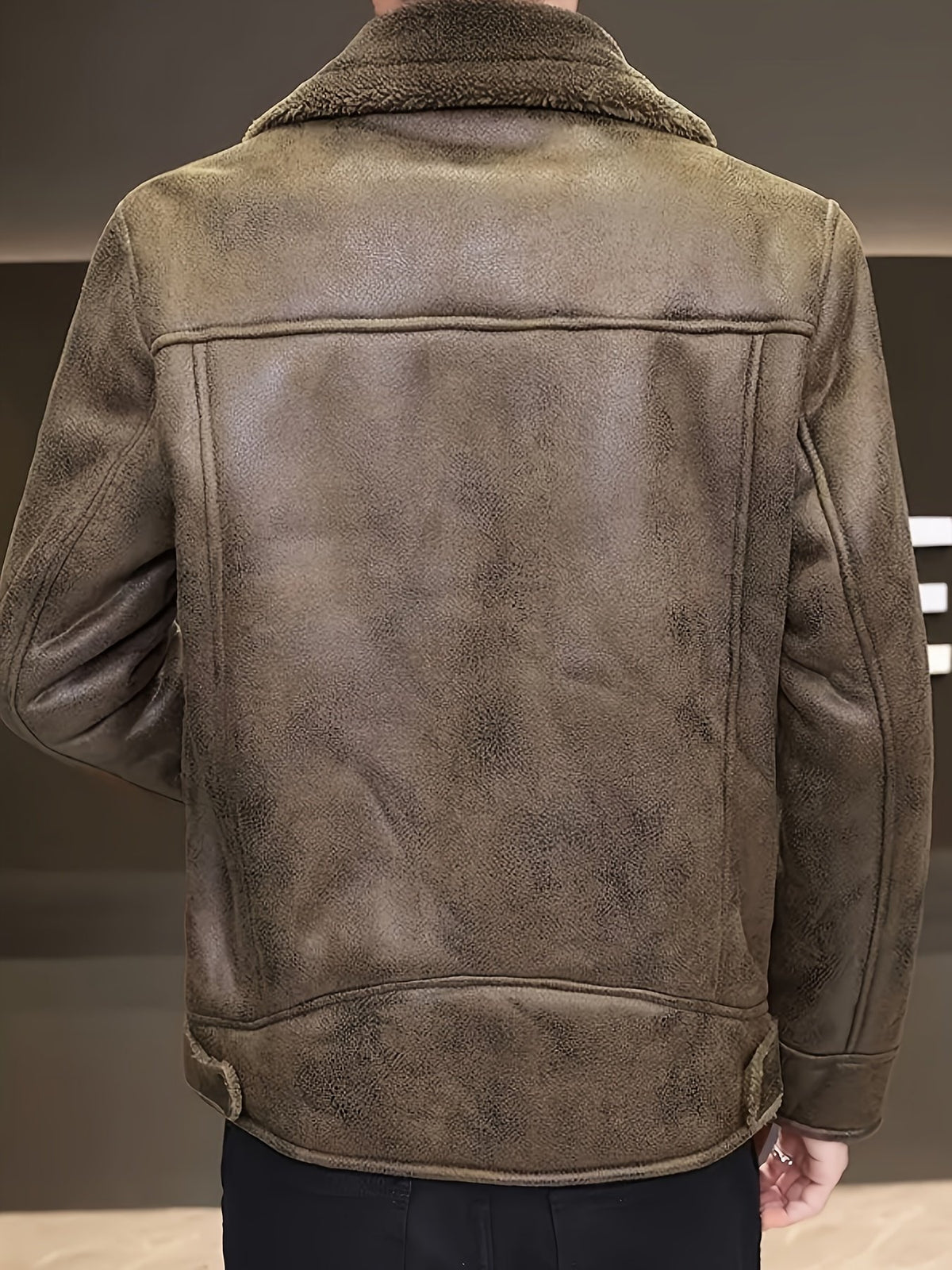 Close-up of the men's faux leather jacket fabric and stitching