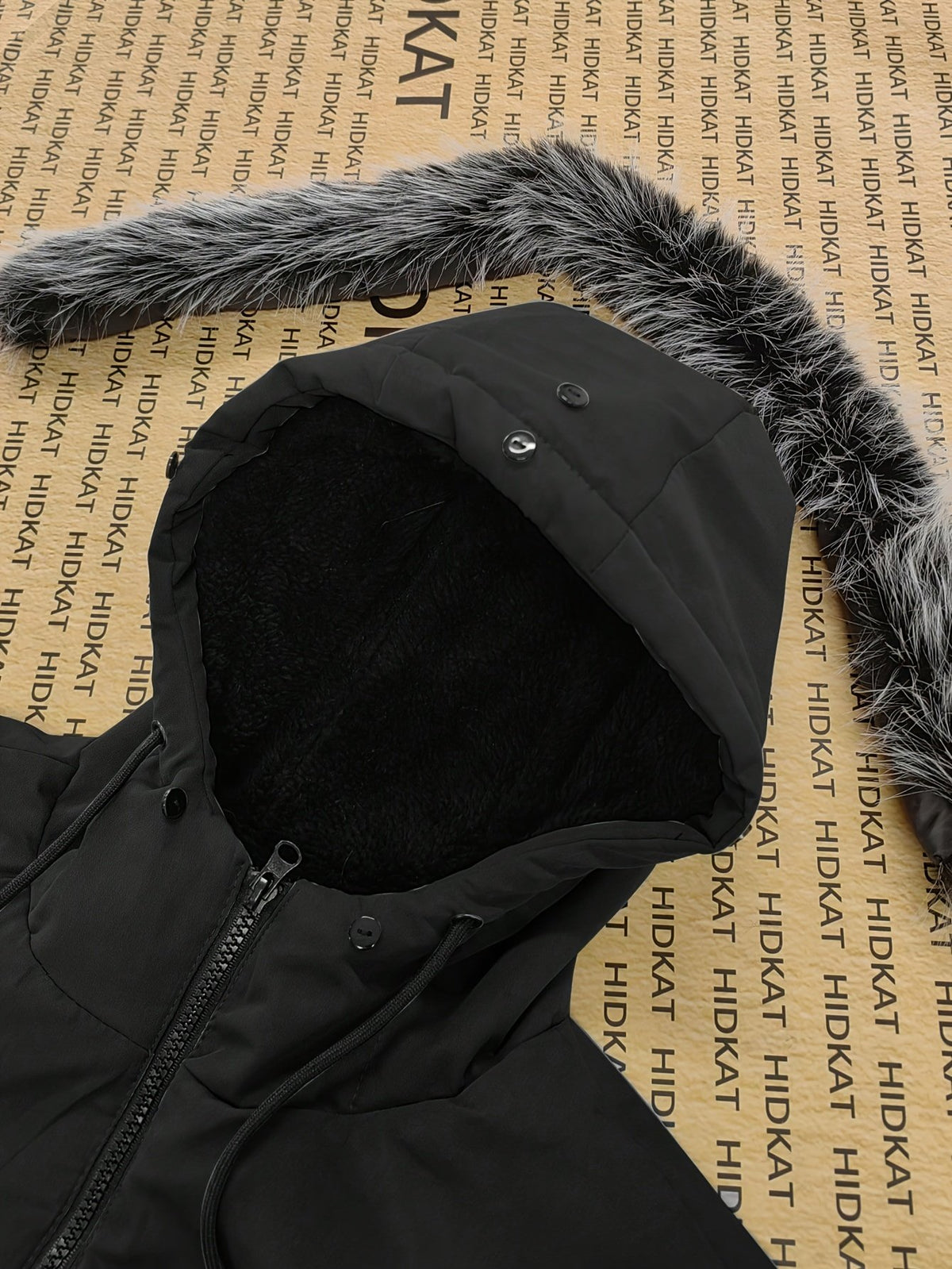 Close-up of the men's knee-length padded coat fabric and stitching