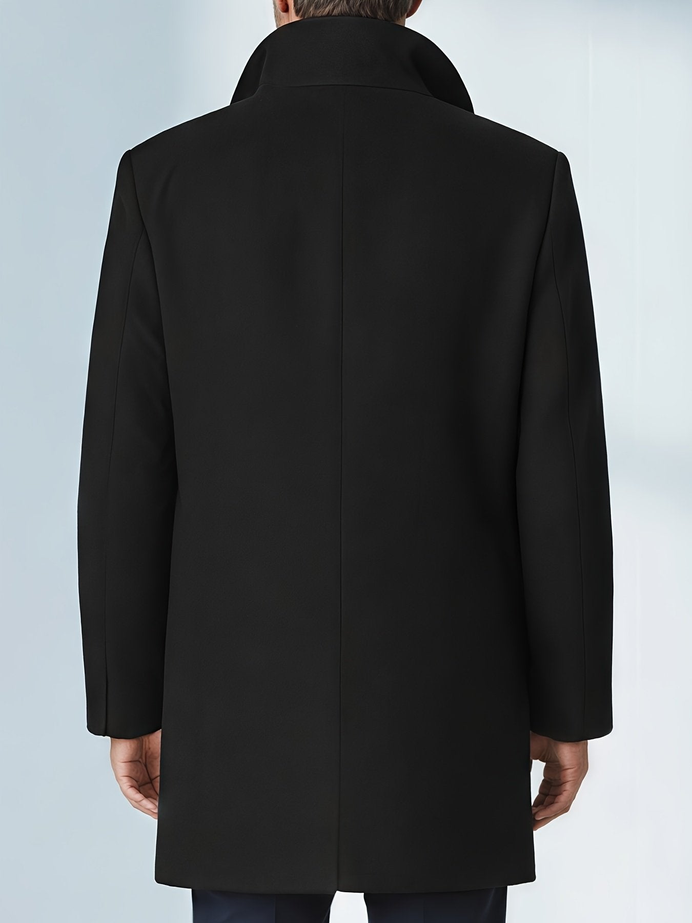 Side view of the men's black trench coat showing the fit