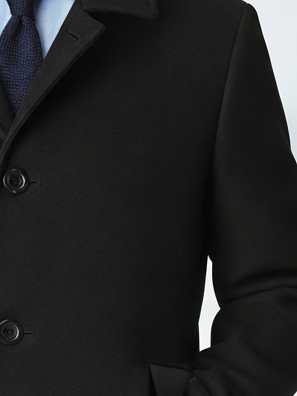 Close-up of the men's black trench coat fabric and stitching