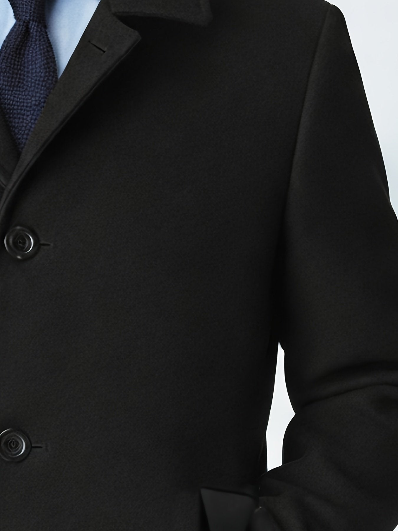 Close-up of the men's black trench coat fabric and stitching