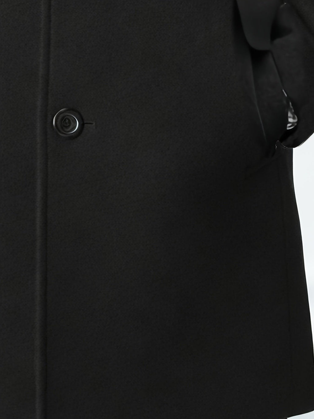 Men's black trench coat styled with jeans for cold weather