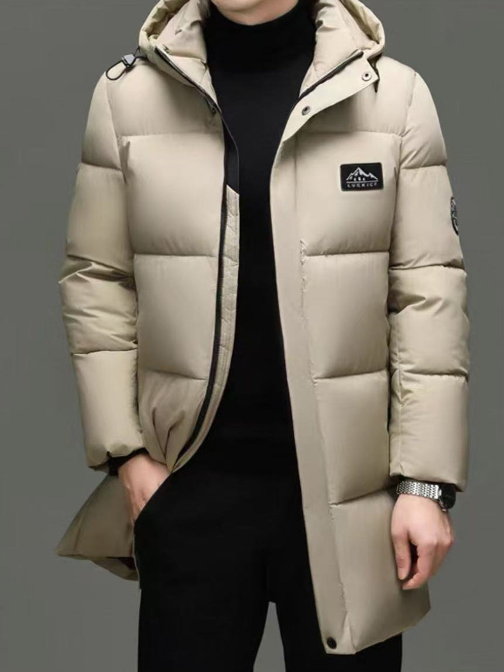 Men's mid-length hooded padded coat styled with jeans for cold weather