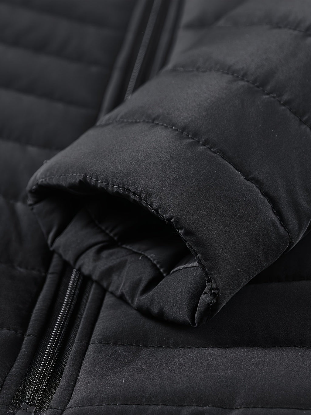 Close-up of the men's slim padded winter jacket fabric and stitching