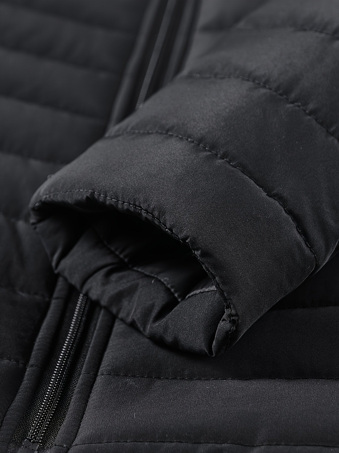 Close-up of the men's slim padded winter jacket fabric and stitching