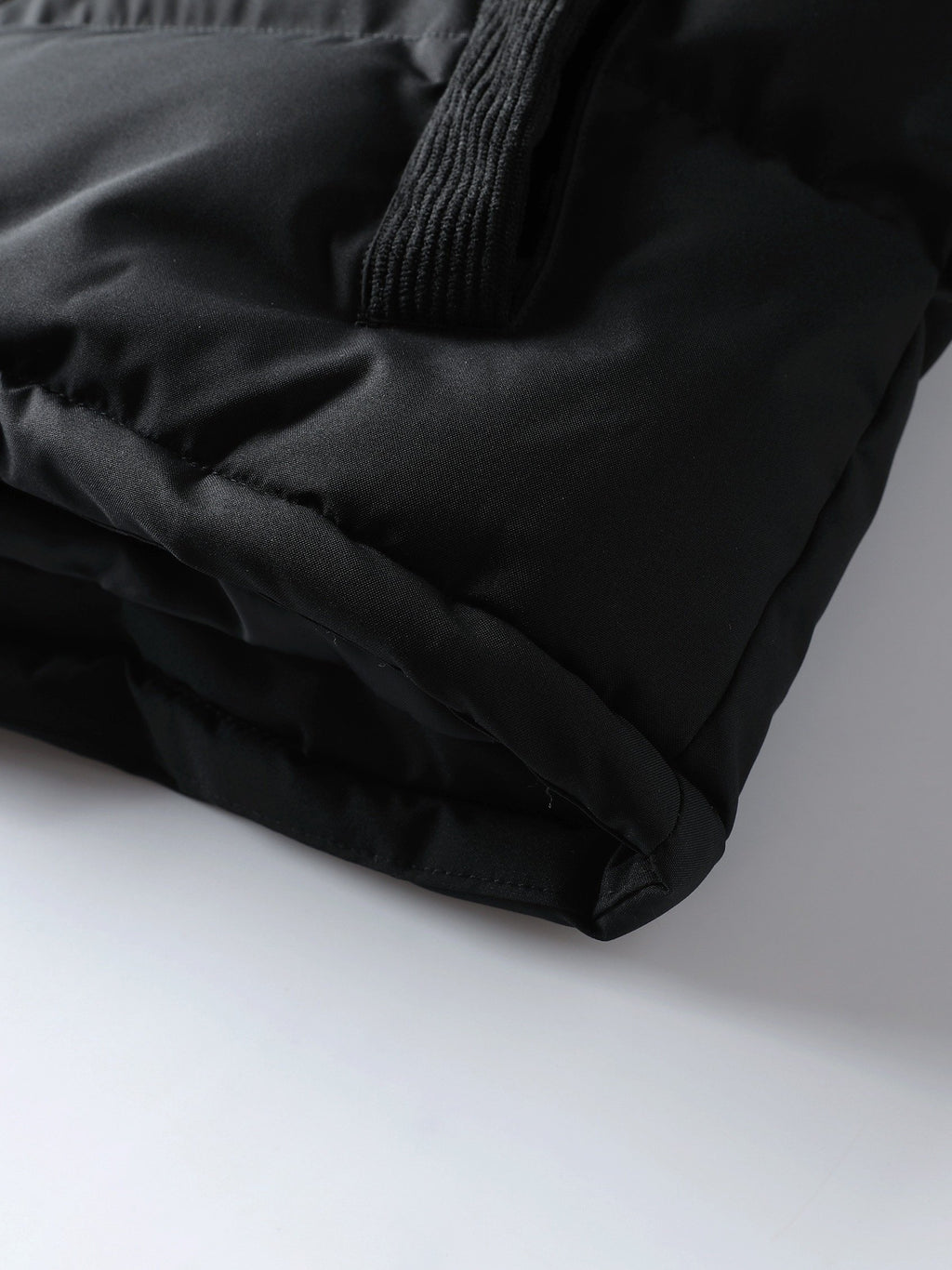 Men's spliced hooded coat styled with jeans for cold weather