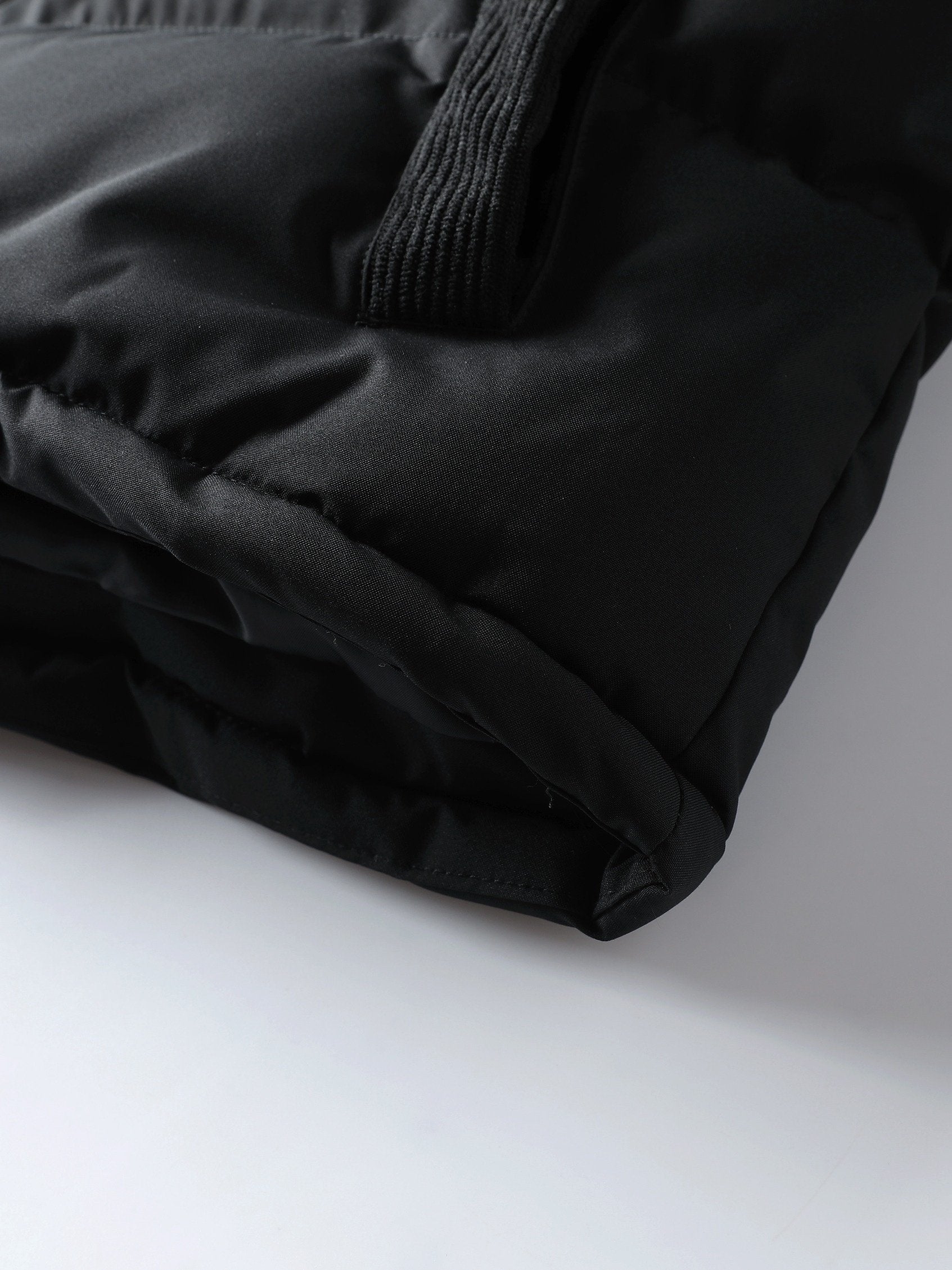 Men's spliced hooded coat styled with jeans for cold weather